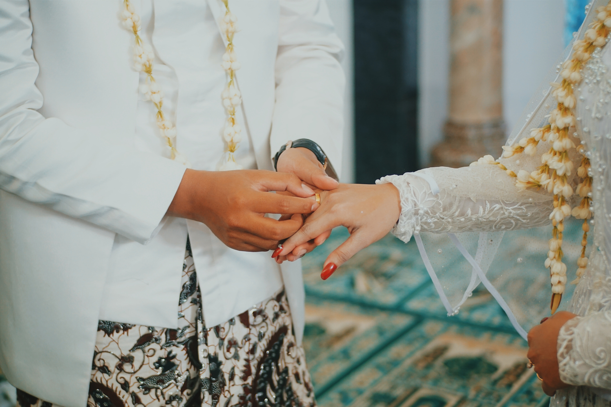 Man Putting a Gold-colored Ring to a Woman's Hand